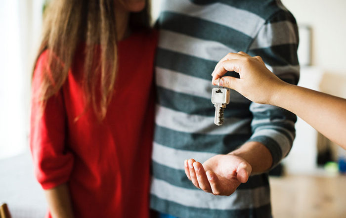 Couple receiving the keys of their house